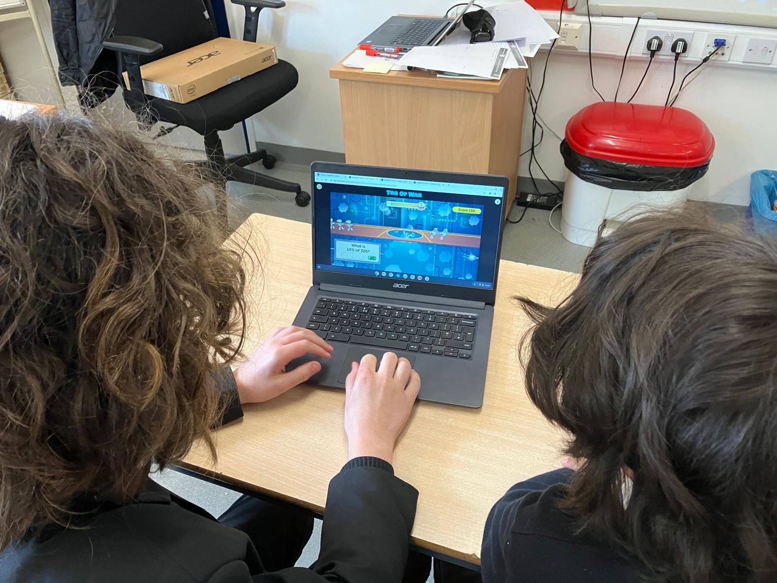 Students learning in a computer classroom